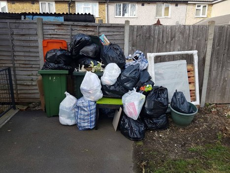 Household renovation waste being loaded into a skip